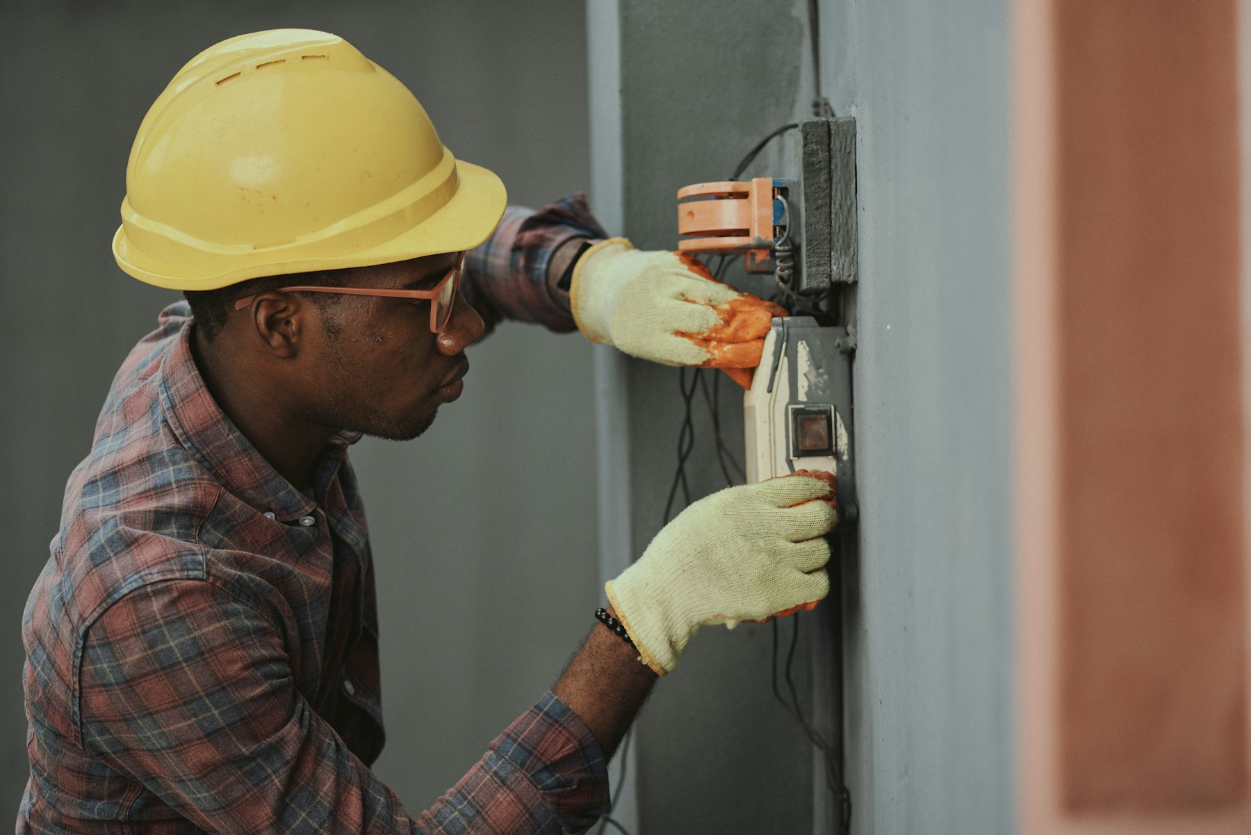 Professional electrician inspecting a residential electrical panel